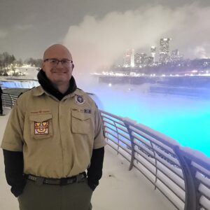 Rob Dusher standing in front of Niagara Falls at night in the snow