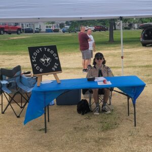 Eagle Scout Owen Shotwell sitting at a table to collect instruments 